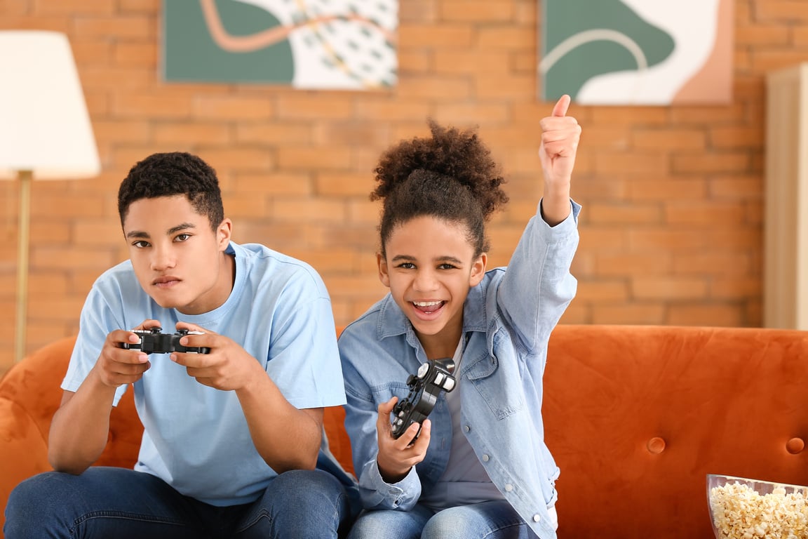 Siblings Playing Video Game at Home