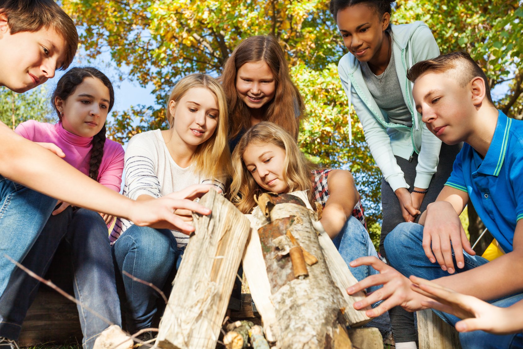 International Teens Construct Bonfire Together