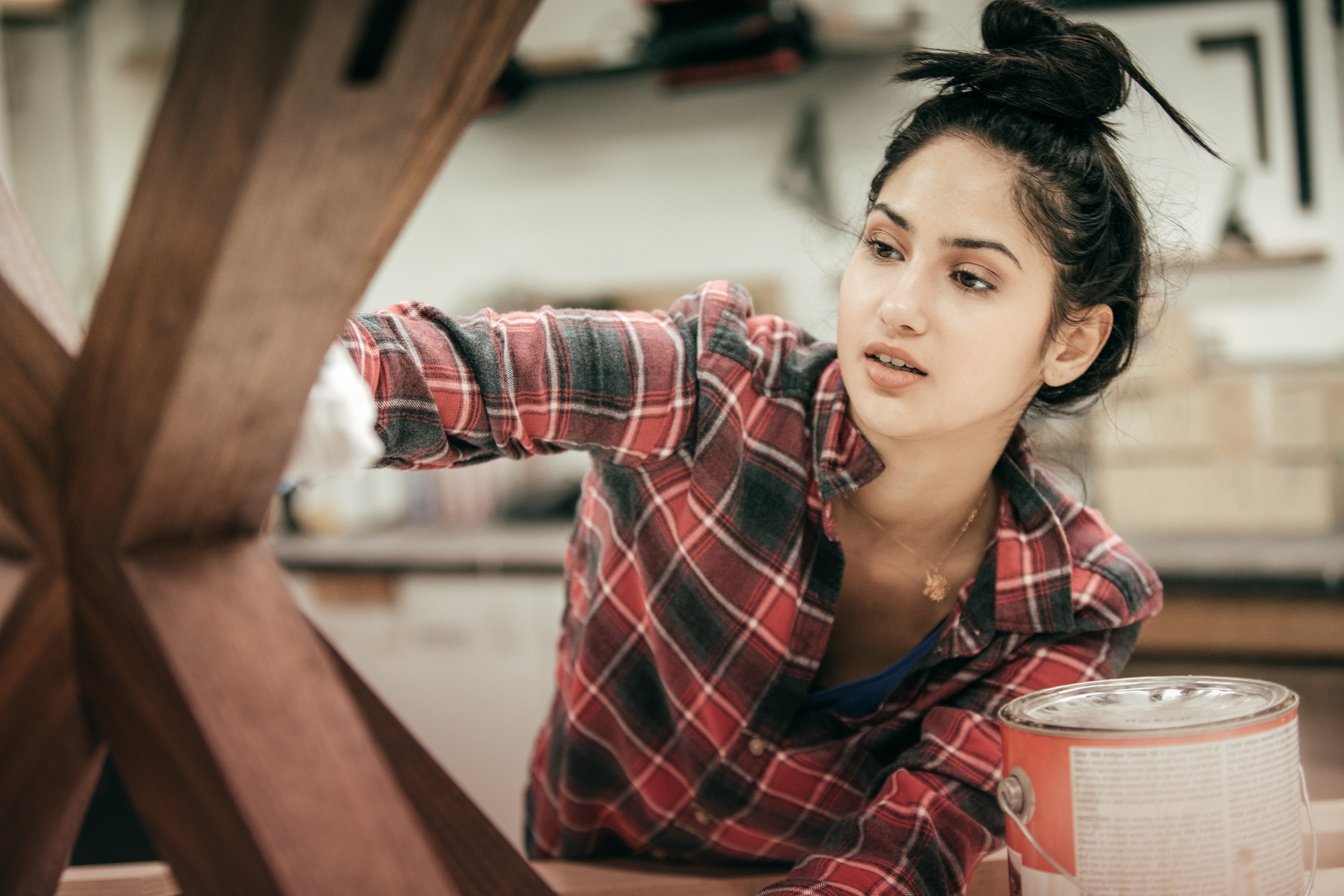 Teen working at woodworking studio